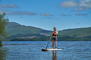 A person Paddleboarding on Loch Lomond